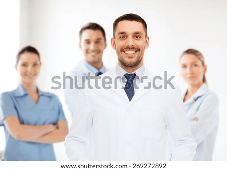 healthcare, profession and medicine concept - smiling male doctor in white coat over white background
