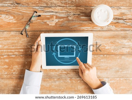 business, education, people and technology concept - close up of female hands pointing finger and restarting tablet pc computer at table