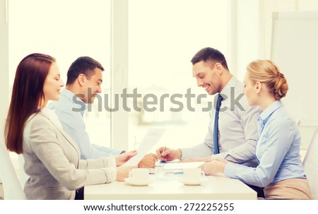 business and office concept - smiling business team having meeting in office