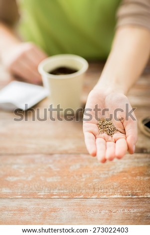 people, gardening, seeding and profession concept - close up of woman hand holding and showing seeds