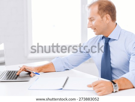 business, office, school and education concept - smiling businessman working in office