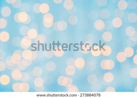 holidays, party and celebration concept - blurred blue and golden background with bokeh lights