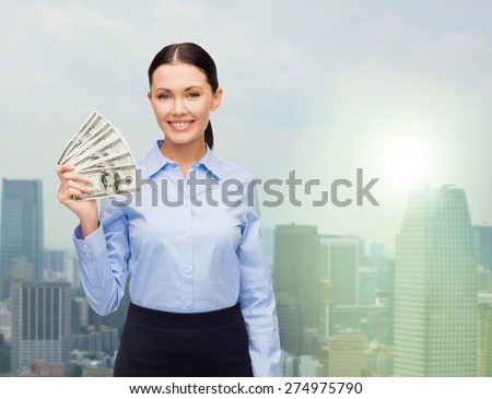 business and money concept - young businesswoman with dollar cash money over city background