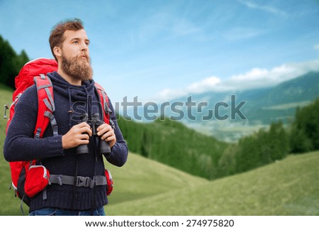 adventure, travel, tourism, hike and people concept - man with red backpack and binocular over alpine hills background