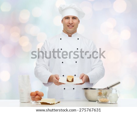 cooking, profession, haute cuisine, food and people concept - happy male chef cook baking dessert over blue lights background