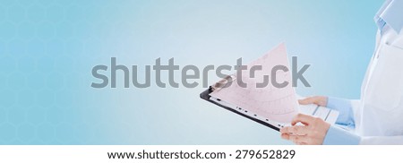 healthcare, cardiology, people and medicine concept - close up of female holding clipboard with cardiogram