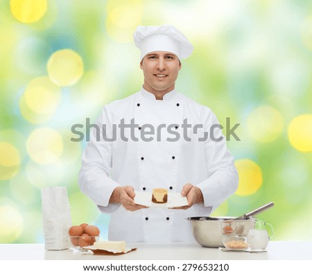 cooking, profession, haute cuisine, food and people concept - happy male chef cook baking dessert over green lights background