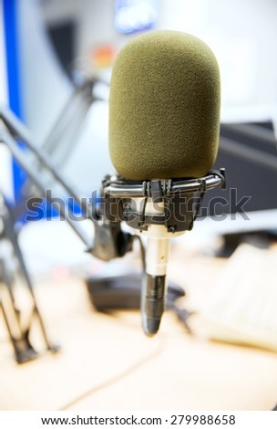 technology, electronics and audio equipment concept - close up of microphone at recording studio or radio station