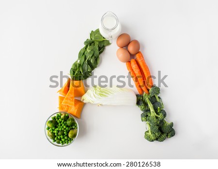 healthy eating, vegetarian food, diet and culinary concept - close up of ripe vegetables in shape of a letter