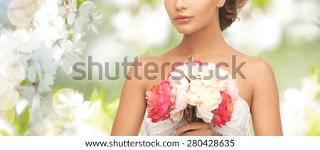 wedding, holidays, people and celebration concept- bride or woman with bouquet of flowers over summer garden and cherry blossom background