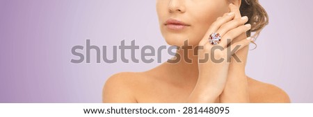 beauty, jewelry, people and accessories concept - close up of woman with cocktail ring on hand over violet background