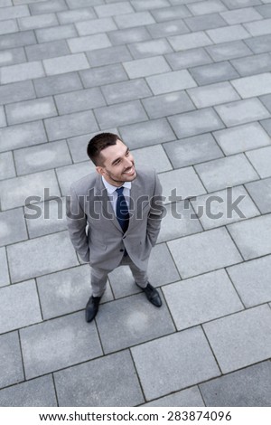 business, development and people and concept - young smiling businessman outdoors from top