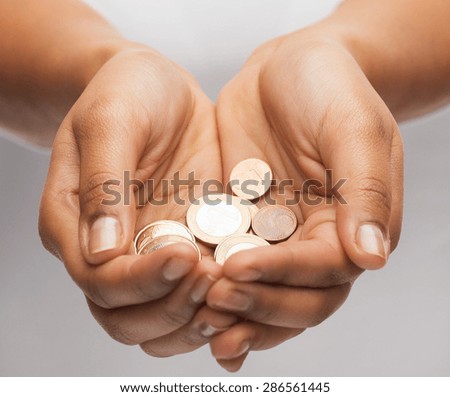money and finances concept - close up of womans cupped hands showing euro coins