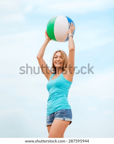 summer holidays, vacation and beach activities - girl playing ball on the beach