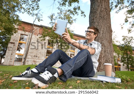 education, people, technology , drinks and learning concept - happy teenage boy with tablet pc computer and coffee cup taking selfie at campus