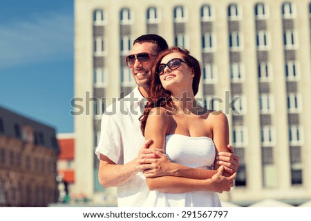 love, wedding, summer, dating and people concept - smiling couple wearing sunglasses hugging in city