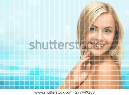 beauty, people and health concept - beautiful young woman with bare shoulders touching her face over blue background with squared grid