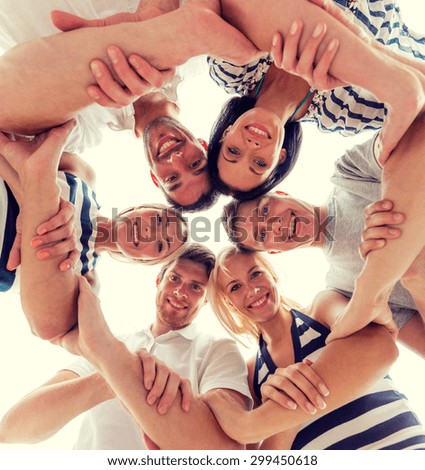 friendship, happiness and people concept - smiling friends in circle