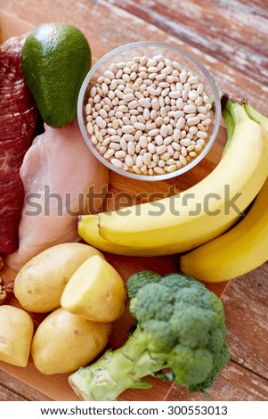balanced diet, cooking, culinary and food concept - close up of different food items on wooden table