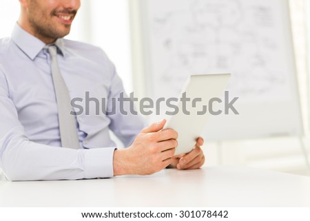 business, people and technology concept - close up of businessman hands with tablet pc computer at office