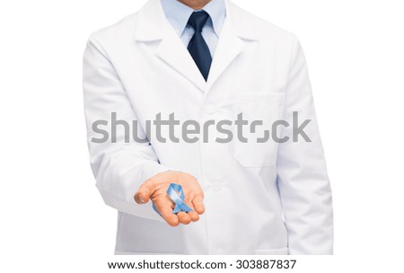 healthcare, profession, people and medicine concept - close up of male doctor in white coat holding sky blue prostate cancer awareness ribbon