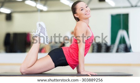 fitness, sport, training, gym and lifestyle concept - beautiful sporty woman doing exercise on the floor at gym