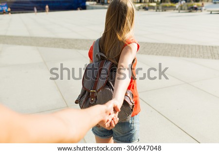 travel, summer vacation, tourism and love concept - close up of couple with backpack in city