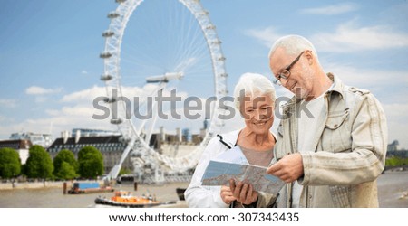 family, age, tourism, travel and people concept - senior couple with map over london ferry wheel background