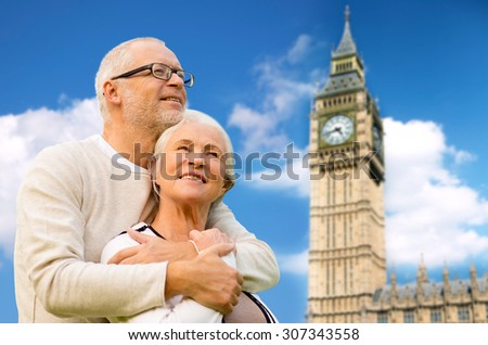 family, age, tourism, travel and people concept - happy senior couple hugging over big ben clock tower in london