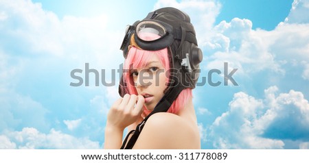 people, sexuality and role-playing games concept - pink hair girl in aviator helmet over blue sky and clouds background