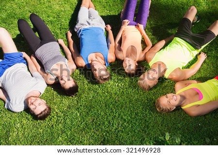 fitness, sport, friendship and healthy lifestyle concept - group of happy teenage friends in circle outdoors
