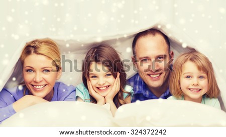 family, children and people concept - happy family with two kids under blanket at home