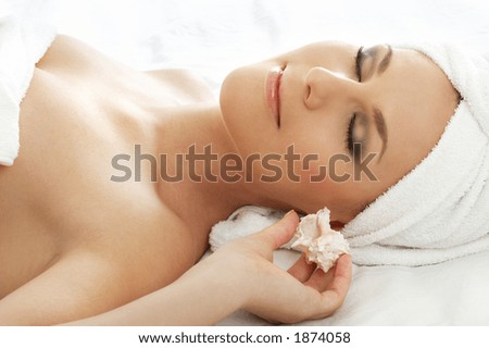 beautiful lady with sea shell in spa