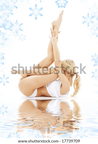 fit blond in white underwear practicing yoga on white sand