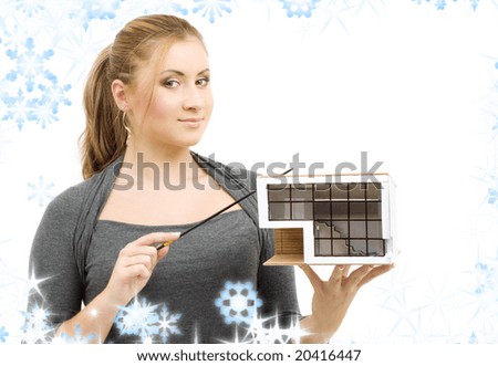 lovely lady with small house model and pointer in hands