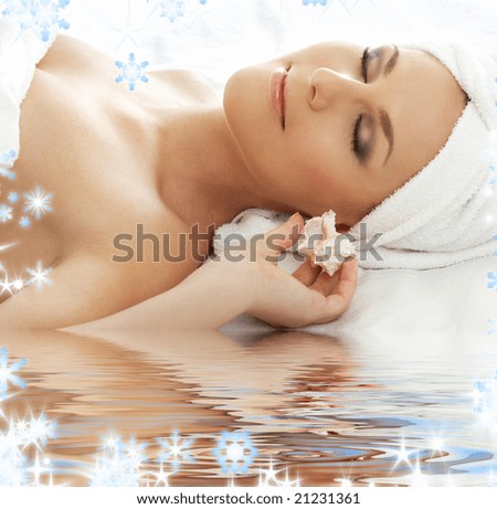 beautiful lady with sea shell in spa