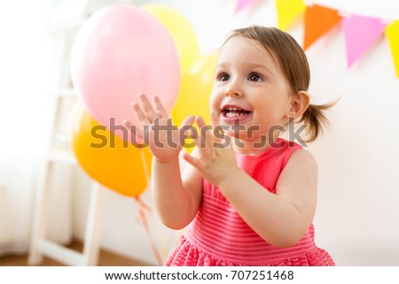 Childhood People And Celebration Concept Happy Baby Girl On Birthday Party At Home Childhood People And Celebration Concept Happy Baby Girl On Birthday Party At Home