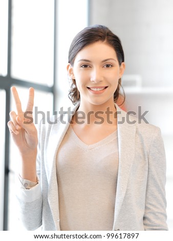 picture of lovely teenage girl showing victory or peace sign