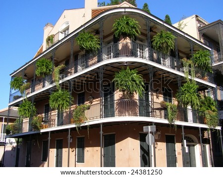 Three story apartment building with wrought iron balcony in the historic French Quarter in New Orleans, Louisiana