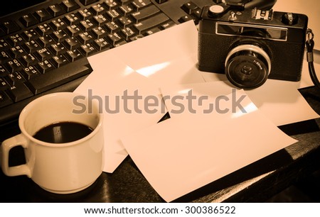 vintage camera and blank photograph on working desk