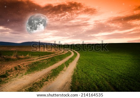 Dirt road in the night. Elements of this image furnished by NASA.