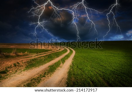 Thunderstorm with lightning in dirt road.