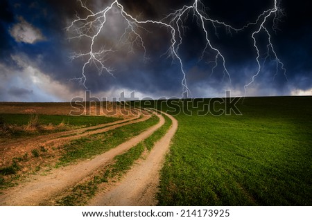 Thunderstorm with lightning in dirt road.