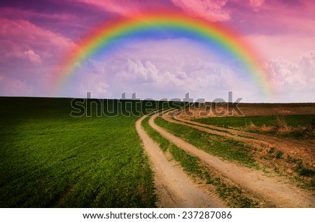 Dirt road and rainbow in the night. Elements of this image furnished by NASA.