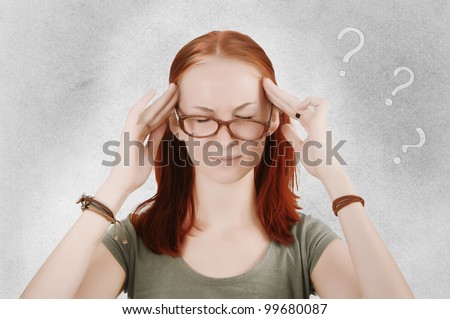 Beautiful young woman holding her head, eyes closed, with question marks above.