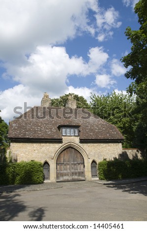 A medieval gate house with a n arched wooden door