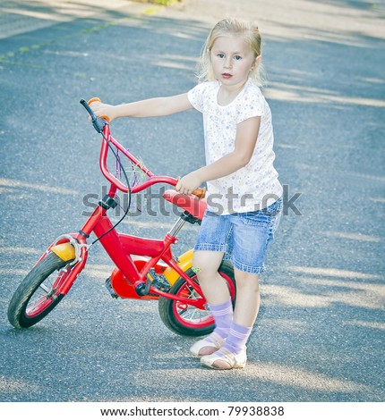 Little blond girl with red bike,\
See my portfolio for more