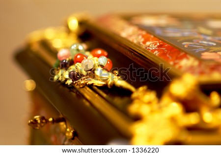 On this jewelry box, several precious gem stones with gold leaf. More with keyword Series003.