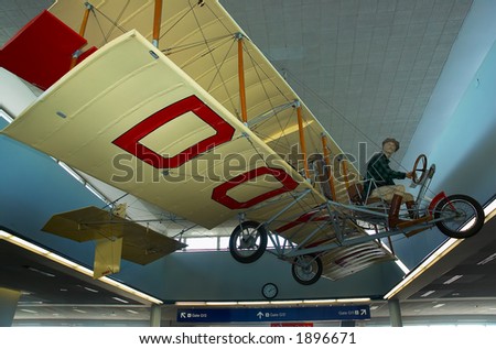 A vintage biplane hanging on the ceiling. More with keyword Series007