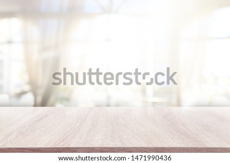 background of wooden table in front of abstract blurred window light Stockfoto © 